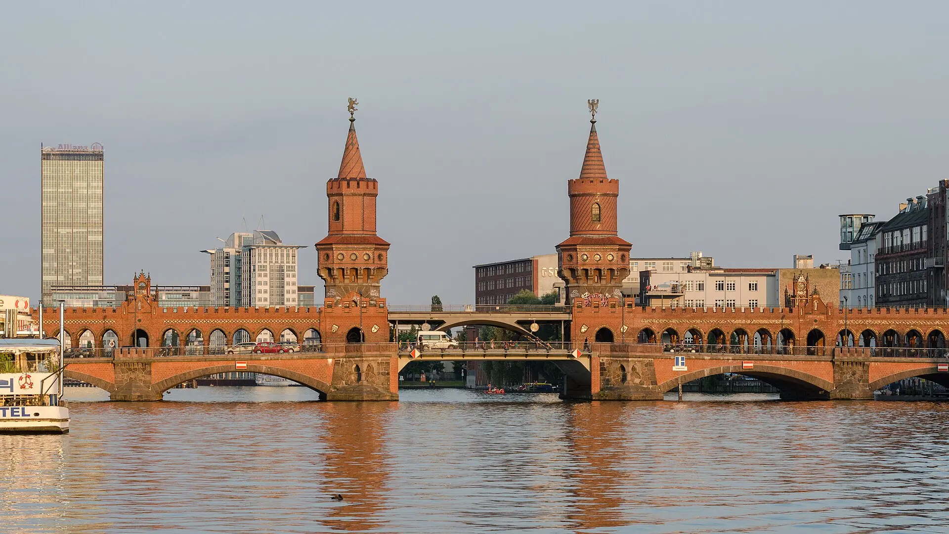 The two brick towers of the Oberbaum bridge in Berlin in warm evening light